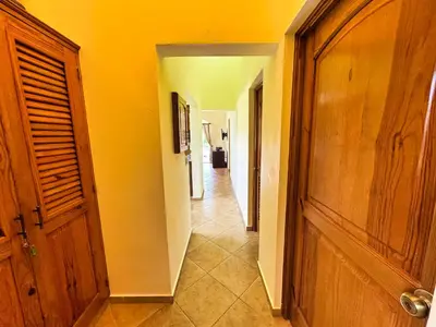 a hallway of a house with a door and a hallwayngthngthngthngthngth at Residencial Hispaniola2 MastersMaidPoolBBQ in Sosúa