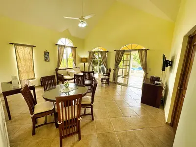 a dining room with a table and chairs at Residencial Hispaniola2 MastersMaidPoolBBQ in Sosúa