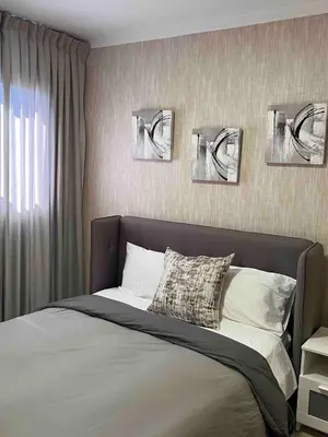 a bedroom with a bed with three pictures on the wall at Beautiful luxury apartment in San Juan de la M in SJM