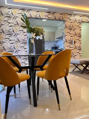 a dining room with a table with yellow chairs at Beautiful luxury apartment in San Juan de la M in SJM