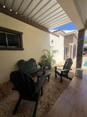 a patio with two chairs and a table and a table at House with Pool and Calm in La Romana