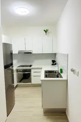 a white kitchen with a sink and a refrigerator at Your ideal getaway awaits! in Punta Cana