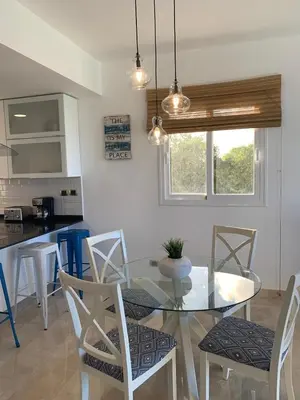 a kitchen and dining room with a glass table and chairs at Casual and comfort condo at Cana Rock Condos in Punta Cana