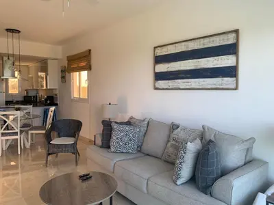 a living room with a couch and a table at Casual and comfort condo at Cana Rock Condos in Punta Cana
