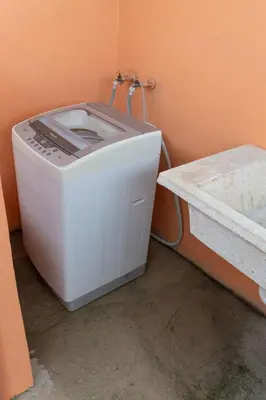 a washing machine sitting in a corner of a bathroom at Magnificent accommodation in Puerto Plata