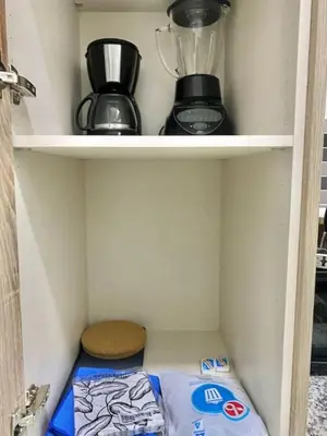a shelf with a blender and a container on it at Cozy, City Center Condo in Santo Domingo