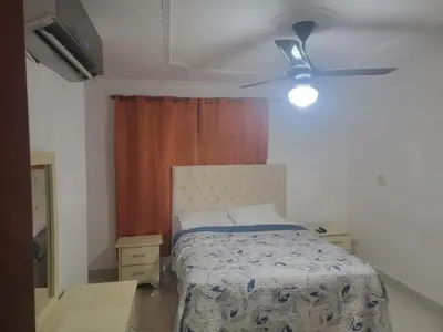 a bedroom with a bed and a ceiling fan at Apartamento Minimalista in Santiago de los Caballeros