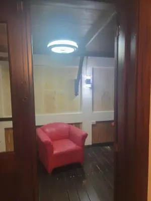 a red chair sitting in the middle of a room at Apartamento Minimalista in Santiago de los Caballeros