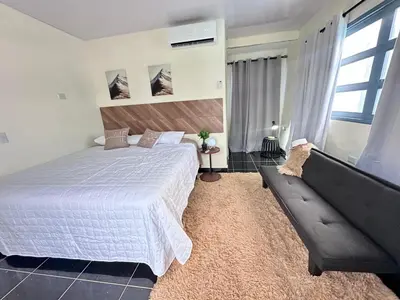 a bedroom with a large white bed and a couch at Villa Seven in Guerra