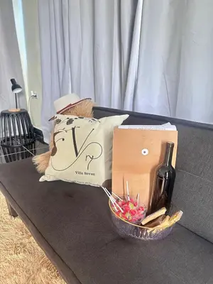 a bottle of wine and a box on a table at Villa Seven in Guerra