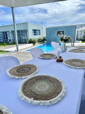 a white table with white chairs and a pool at Villa Seven in Guerra