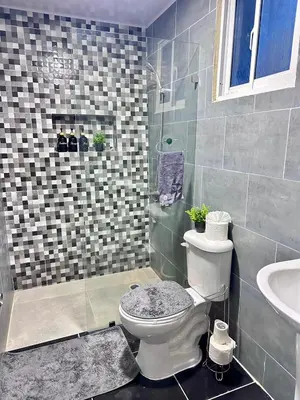 a bathroom with a toilet and a shower and a sink at Villa Seven in Guerra