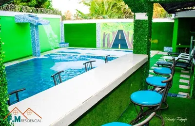 a large swimming pool with chairs and a table at Villa en Pedernales in Pedernales