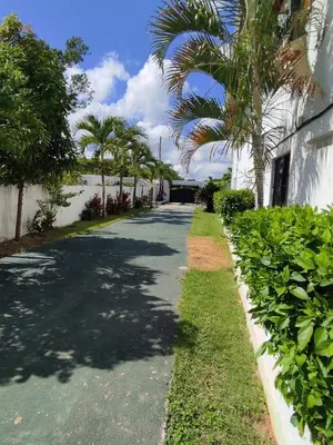 a street with palm trees on the side of a building at Natural Pool Villa perfect for families in Río San Juan