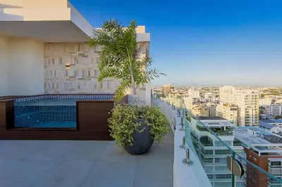 a balcony of a building with two palm trees on it at Upscale Condo, Spectacular Views in Santo Domingo