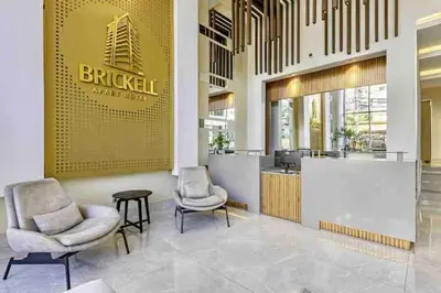 a lobby with two chairs and a counter in a building at Comfy 1BR Apt, King Bed, Pool in Santo Domingo