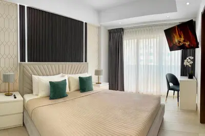 a bedroom with a large bed and a chair at Comfy 1BR Apt, King Bed, Pool in Santo Domingo