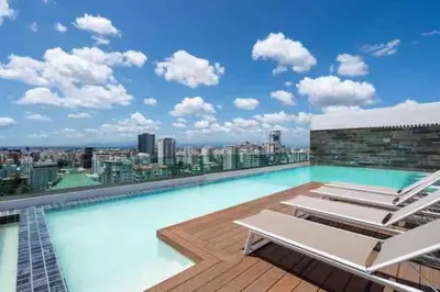 a swimming pool on the roof of a building at Cozy City-Center 1BD Condo, Pool in Santo Domingo