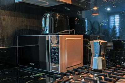 a microwave oven sitting on top of a counter at Cozy City-Center 1BD Condo, Pool in Santo Domingo