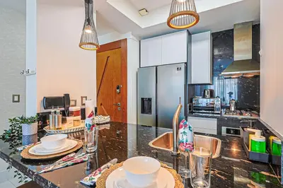 a kitchen with a counter top with dishes on it at Cozy City-Center 1BD Condo, Pool in Santo Domingo