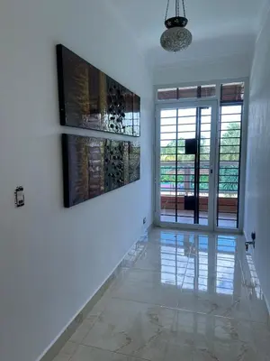 a hallway with white walls and a large window at Luxury Villa with Pool, jacuzzi,Basketball and more