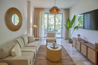 a living room with a couch and a table at Modern Escape with Pool & Beach in Puerto Plata