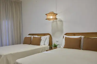 a room with two beds and a chandelier at Modern Escape with Pool & Beach in Puerto Plata