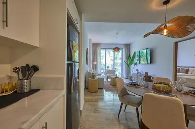 a kitchen and dining room with a table and chairs at Modern Escape with Pool & Beach in Puerto Plata
