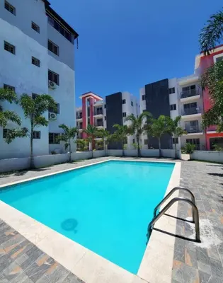 a swimming pool in front of a building at Relax cibao airport stay in Santiago de los Caballeros