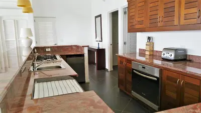 a kitchen with a sink and a stove top oven at Casa Las Piedras in Las Terrenas