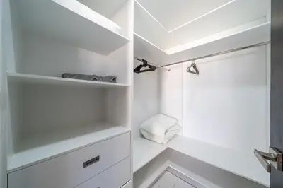 a bathroom with white shelves and a shower at Luxury Villa, Pool & Prime Location in Sosúa