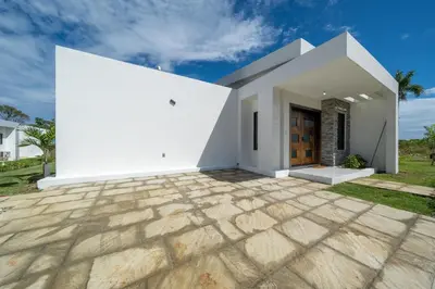 a white house with a stone patio at Luxury Villa, Pool & Prime Location in Sosúa
