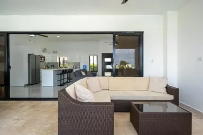 a living room with a couch and a table at Luxury Villa, Pool & Prime Location in Sosúa