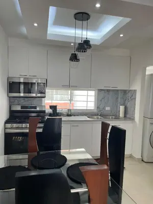 a kitchen with a table and chairs and a stove at Luxurious and cozy apartment in San Luis