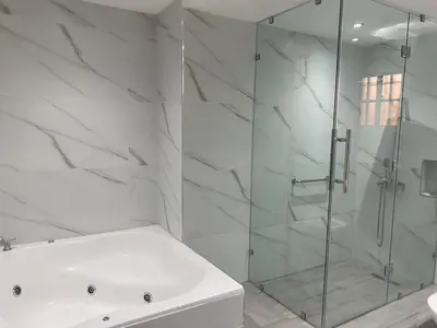 a white bathroom with a shower and a tub at Apartmento, siéntete en casa in Monte Adentro