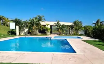 a swimming pool in front of a house at Casa colinas del viento in Jacagua