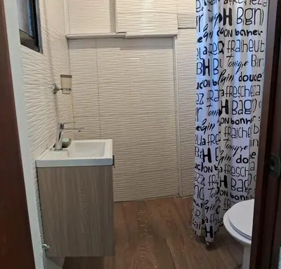 a bathroom with a sink and a toilet at Apartamento Las Carreras in Santo Domingo