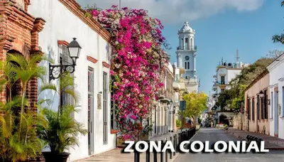 a street with flowers on the side of buildings at Apartamento Las Carreras in Santo Domingo