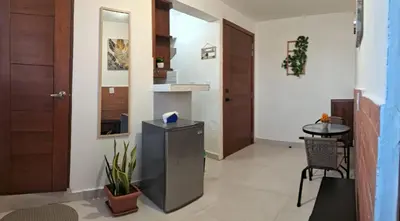 a hallway with a door and a table in a room at Apartamento Las Carreras in Santo Domingo