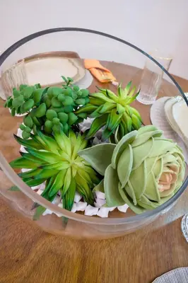 a glass bowl filled with green plants on a table at Amazing 2BR apartment near the airport in Los Frailes