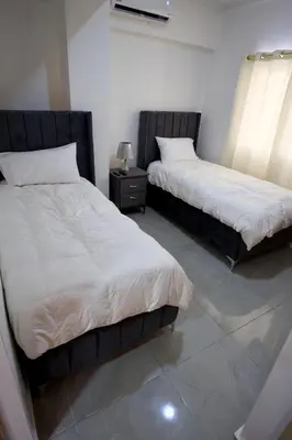two beds sitting next to each other in a room at Amazing 2BR apartment near the airport in Los Frailes