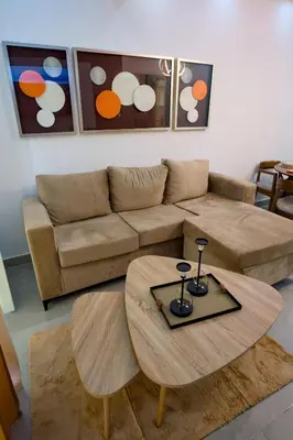 a living room with a couch and a table at Amazing 2BR apartment near the airport in Los Frailes