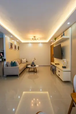 a living room with a couch and a tv at Luxurious Apartment with pool near airport in Santiago de los Caballeros