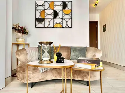 a living room with a couch and a table at Comfy 1BR Apt, Full AC, Pool. in Santo Domingo