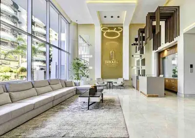 a living room with a large couch in a building at Comfy 1BR Apt, Full AC, Pool. in Santo Domingo