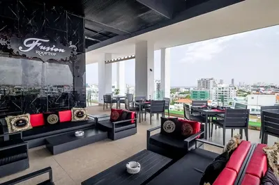 a living room with a couch and tables and chairs at Comfy 1BR Apt, Full AC, Pool. in Santo Domingo