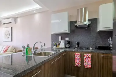 a kitchen with a sink and a counter top at Comfy 1BR Centric Apt King Bed in Santo Domingo