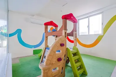 a childrens play room with a wooden play structure at Comfy 1BR Centric Apt King Bed in Santo Domingo