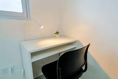 a white desk with a black chair in a room at Comfy 1BR Centric Apt King Bed in Santo Domingo