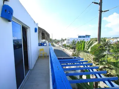 a row of blue benches sitting on a balcony at Brisa de Alma Guesthouse in Bayahibe